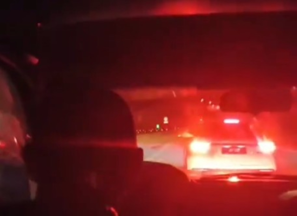 A screengrab from a video shows a vehicle slowing down in front of a family’s vehicle during the incident near the Menora Tunnel, Perak. — Screengrab via Facebook