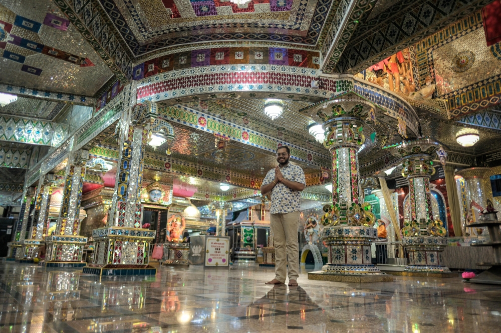 Treasurer of the Arulmigu Sri Rajakaliamman Glass Temple, S. Maheshwara, poses inside the temple adorned with about 300,000 colourful glass pieces in Johor Baru. — Photo by Bernama.