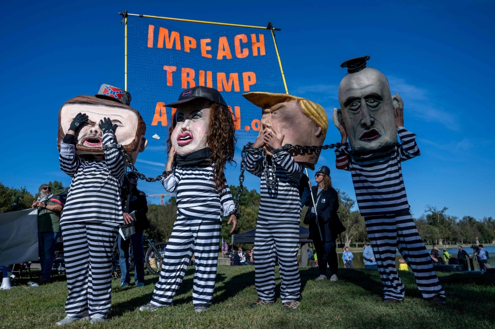 Protesters dressed as caricatures of (from left) US Vice President JD Vance, Secretary of Homeland Security Kristi Noem, President Donald Trump and Deputy Chief of Staff Steven Millerrally on the National Mall in Washington, DC, on October 17, 2025, ahead of nationwide ‘No Kings’ protests. — AFP