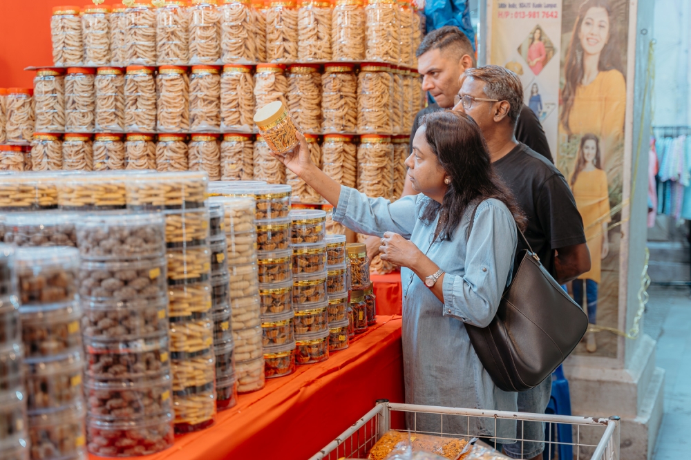 Shoppers looking at a variety of Deepavali delicacies and snacks sold by small traders at the Deepavali bazaar in Brickfields, Kuala Lumpur recently. — Picture by Raymond Manuel