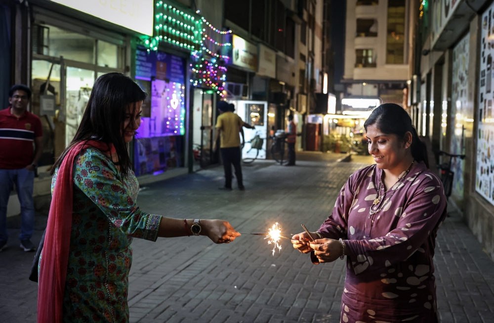 One practice is called ‘ulka danam’, in which Hindus hold sparklers in their hands to bid goodbye to their ancestors on Deepavali day. — AFP pic