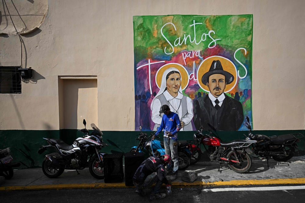A mural in Caracas shows Venezuela's first two saints to be canonised on October 19, 2025 – Sister Maria and Dr Jose Gregorio Hernandez. — AFP pic