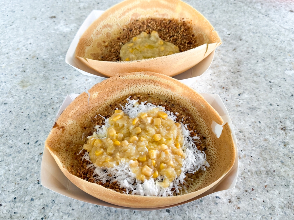 ‘Apam balik’ is served crunchy and topped with your favourite flavours like this version with freshly grated coconut, sweet corn and toasted peanuts. — Picture by Lee Khang Yi