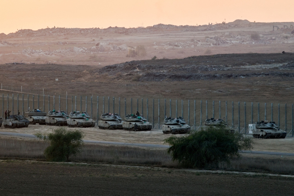 Israeli military vehicles stand on the Israeli side of the border with Gaza October 19, 2025. — Reuters pic  