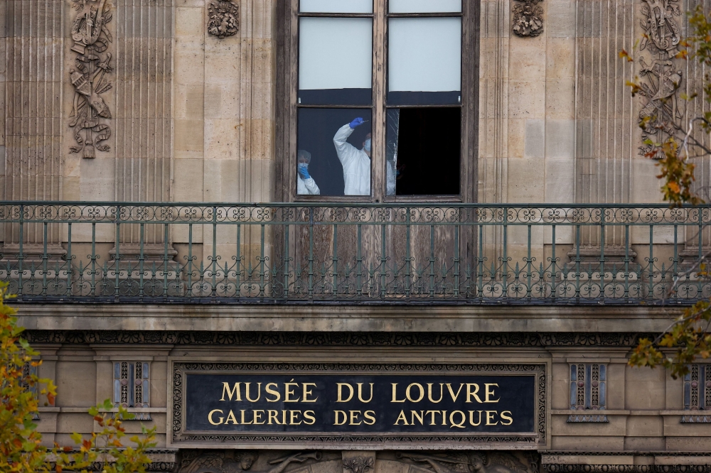 Members of a forensic team inspect a window believed to have been used in what the French Interior Ministry said was a robbery at the Louvre museum during which jewellery was stolen, in Paris October 19, 2025. — Reuters pic 