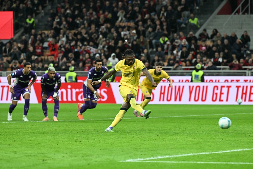 AC Milan's Portuguese forward #10 Rafael Leao kicks and scores a penalty during the Italian Serie A football match between AC Milan and Fiorentina at San Siro stadium in Milan October 19, 2025. — AFP pic 