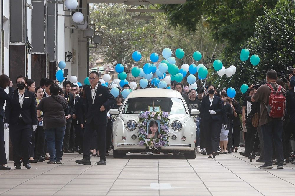 Family and friends escort the late Yap Shing Xuen with blue balloons before the send-off to Nirvana Shah Alam at Nirvana Kuala Lumpur, October 20, 2025. — Picture by Sayuti Zainudin