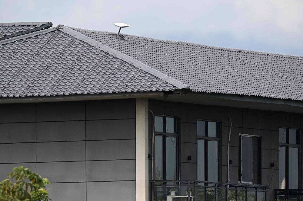 This photo taken on September 17, 2025 shows what appears to be a Starlink satellite dish on the roof of a building at the KK Park complex in Myanmar's eastern Myawaddy township, as pictured from Mae Sot district in Thailand's border province of Tak. — AFP pic 