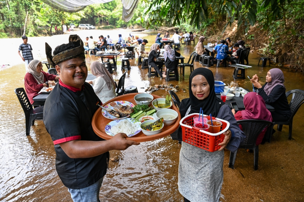 Nasirudin Mohd runs the river-themed eatery with his wife Nur Jannah Anuar. — Bernama pic