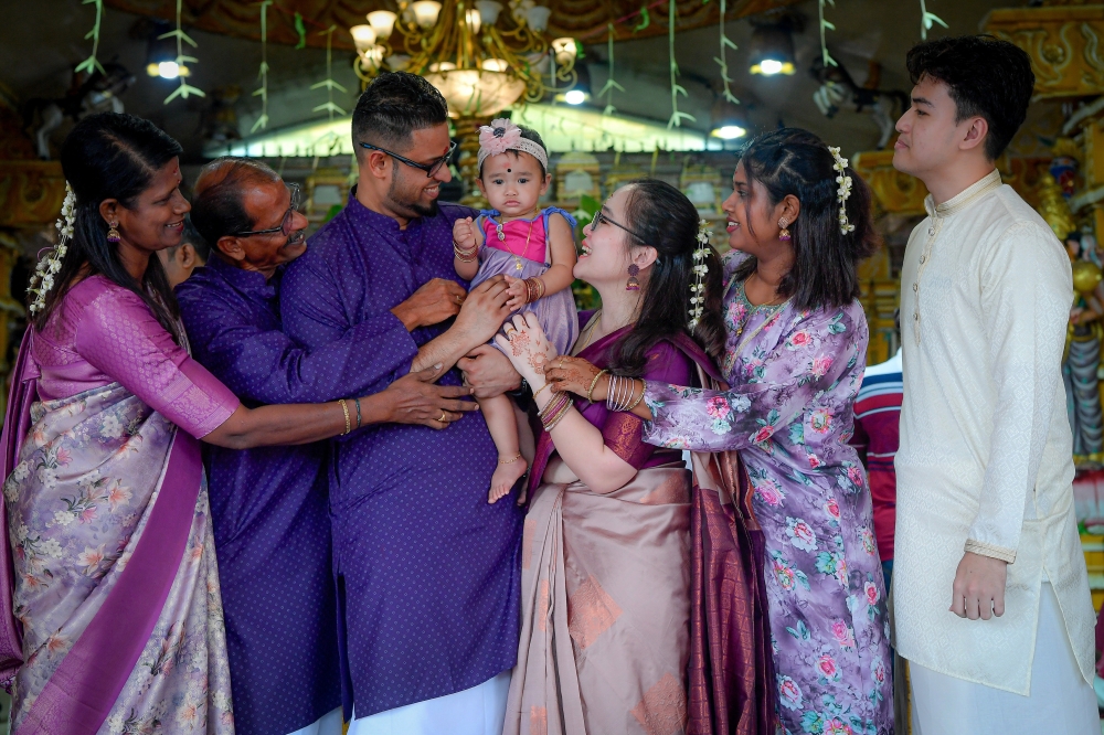 S. Dinesh, 33 (third from left) and his family at the Sri Maahamariaman Devasthanam Temple in Section 7, Shah Alam, October 20, 2025. — Bernama pic 