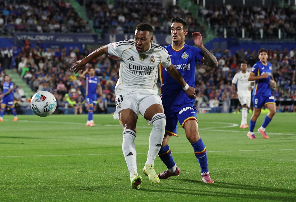 Real Madrid's Kylian Mbappe in action with Getafe's Alex Sancris during their LaLiga match at Estadio Coliseum, Getafe, Spain October 19, 2025. — Reuters pic