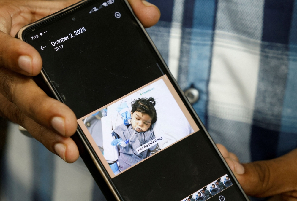 Sushant Kumar Thakre, 32, father of Yojita Thakre, who died after consuming Coldrif cough syrup that has been linked to the deaths of multiple children, shows a picture on a phone of Yojita lying on a hospital bed, in Parasia, Madhya Pradesh, India, October 8, 2025. — Reuters pic