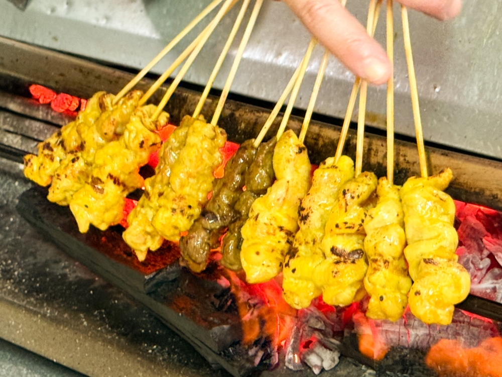 The satay is cooked till the meat is lightly charred, which helps the meat to retain its juiciness. — Picture by Lee Khang Yi