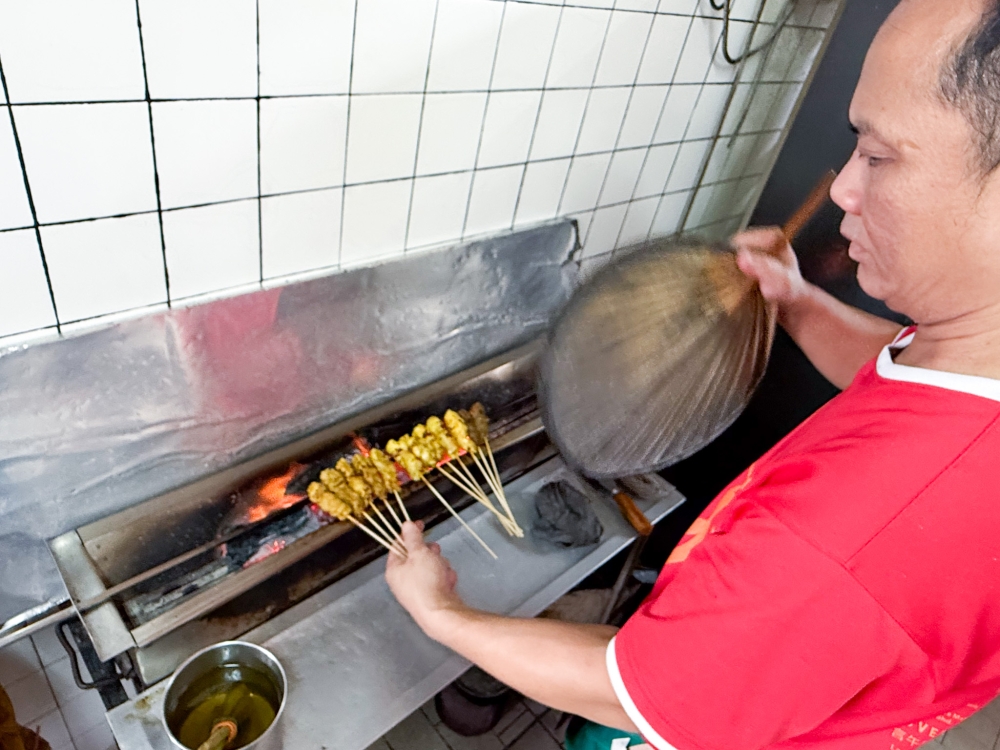 Each piece of satay is cooked over a charcoal fire. — Picture by Lee Khang Yi