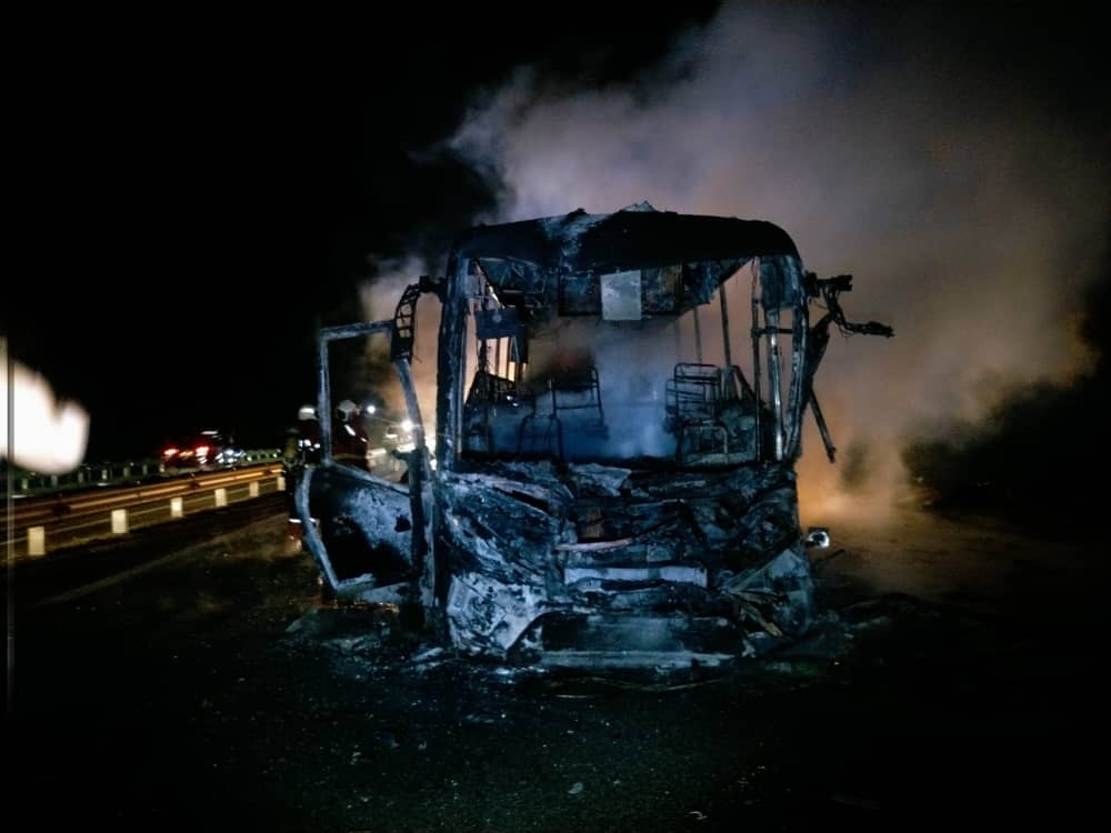 The gutted express bus that caught fire after colliding with a lorry at Kilometre 78.7 of the North-South Expressway near Kluang late last night. — Picture courtesy of the Johor Fire and Rescue Department.