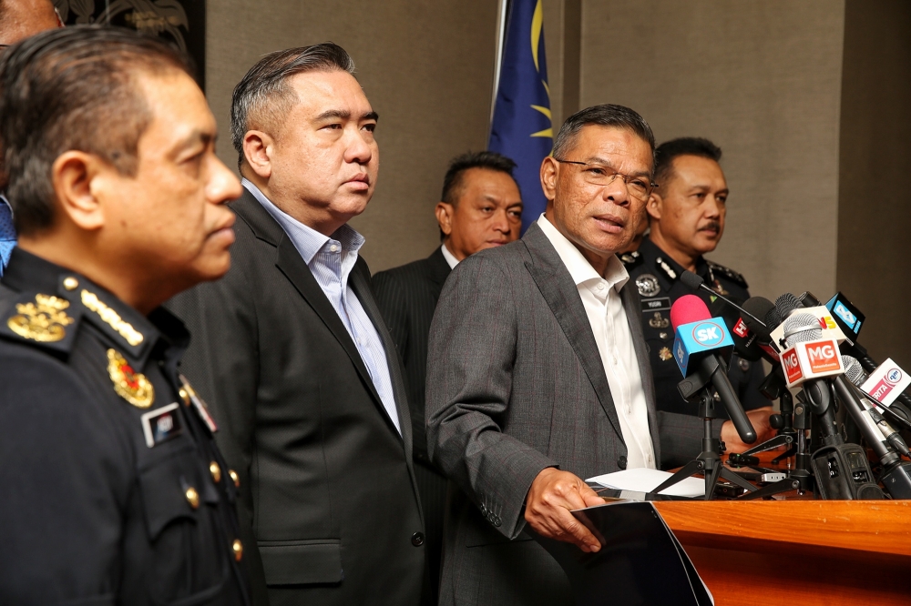Home Minister Datuk Seri Saifuddin Nasution Ismail is seen here with Transport Minister Anthony Loke at a joint press conference in Parliament. Saifuddin confirmed that public gatherings will be allowed during the upcoming Asean summit provided they follow security protocol. — Picture by Choo Choo May.