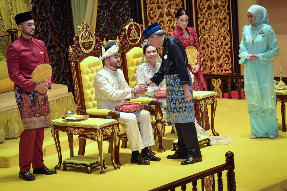 The ceremonial blessing or ‘merenjis’, was first performed by the Sultan and the Tengku Permaisuri, followed by the groom’s mother, Puan Nurlisa Idris Abdullah and the bride’s parents. — Bernama pic