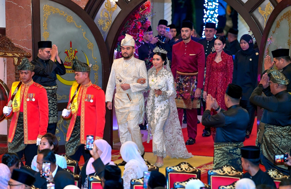 At 7.45pm, the bride and groom, elegantly attired in cream royal attire, made their entrance accompanied by members of the Selangor royal family. — Bernama pic