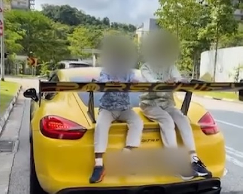 Dashcam footage shows two children riding on the back of a yellow Porsche Cayman along Dairy Farm Walk near Bukit Panjang, Singapore, as police investigate the incident. — Screengrab via TikTok