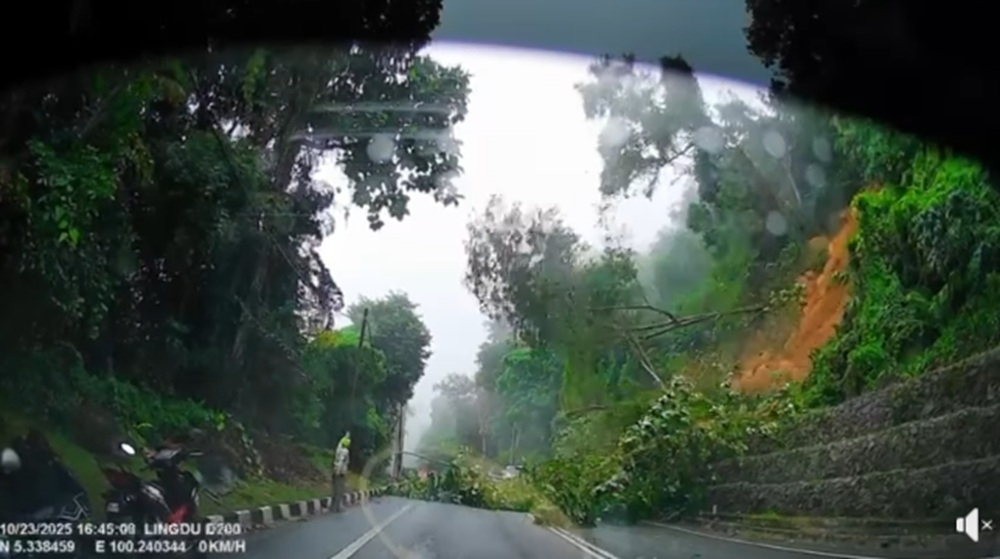Jalan Tun Sardon in Balik Pulau, Penang, was temporarily closed today following a landslide and fallen trees. — Video screencap via Facebook/Poh Kheng Mak