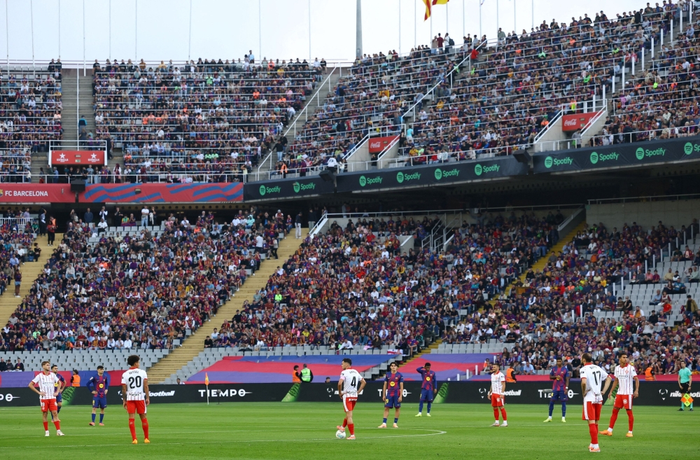 Players protest at kick-off during the La Liga match between Barcelona and Girona at Estadi Olimpic Lluis Companys in Barcelona October 18, 2025, due to the La Liga’s relocation of the Villarreal vs FC Barcelona match to Miami. — Reuters pic