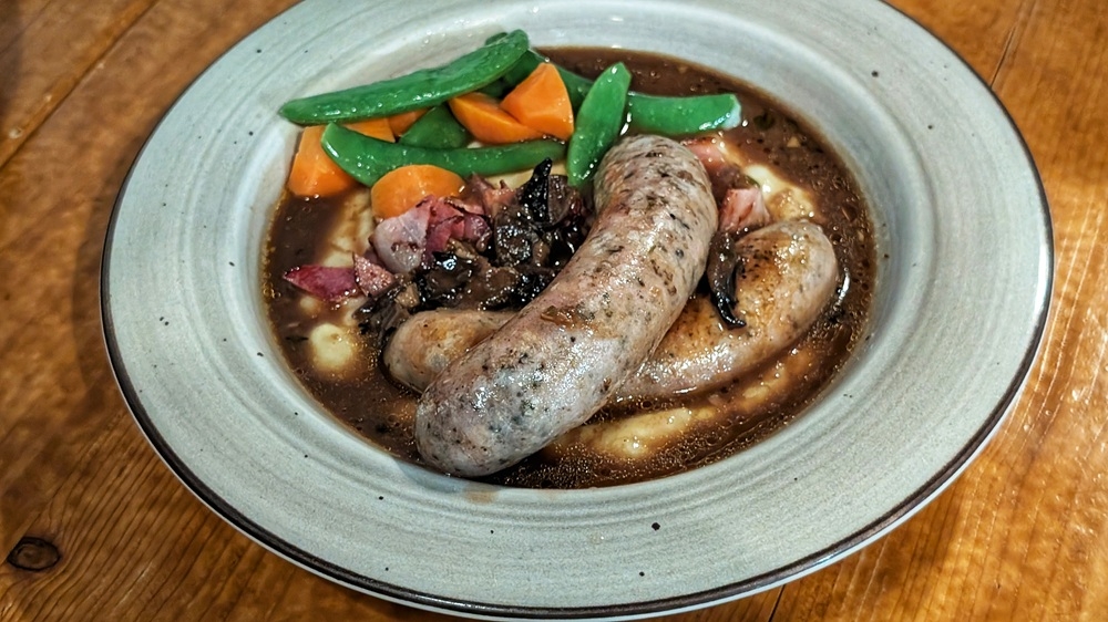 The bangers and mash have just enough sauce, despite how it might initially appear. — Picture by Ethan Lau