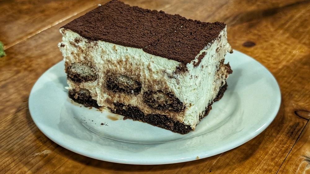 Classic tiramisu, gladly scooped out of a tray here. — Picture by Ethan Lau