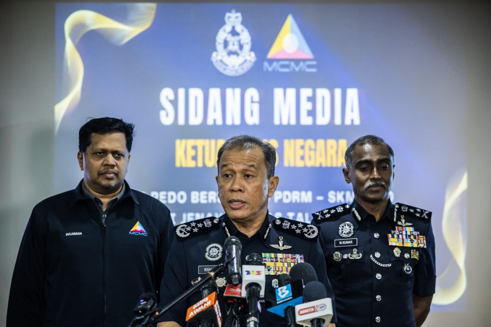 Inspector-General of Police Datuk Seri Mohd Khalid Ismail (centre) speaks during a press conference at the Bukit Aman police headquarters in Kuala Lumpur on October 24, 2025. — Picture by Firdaus Latif