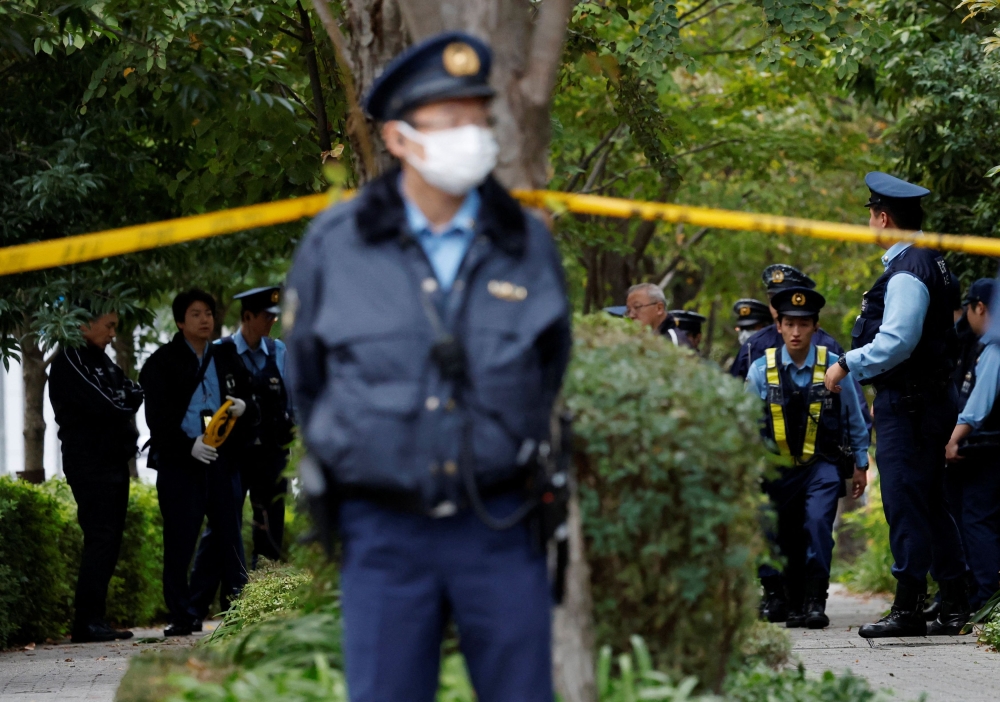 Policemen investigate a site where a man wielding a knife was arrested, near the US embassy in Tokyo, Japan, October 24, 2025. — Reuters pic