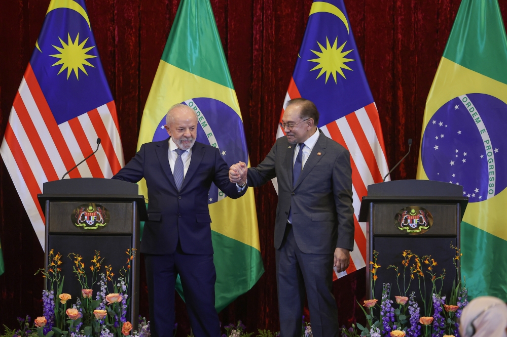Prime Minister Datuk Seri Anwar Ibrahim with Brazilian President Luiz Inácio Lula da Silva gesture after a press conference following their bilateral meeting at Seri Perdana Complex in Putrajaya October 25, 2025. — Bernama pic