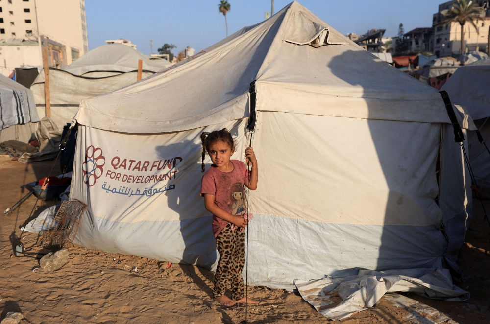 A Palestinian child looks on in front of a tent, amid a ceasefire between Israel and Hamas, in Gaza City October 20, 2025. — Reuters pic