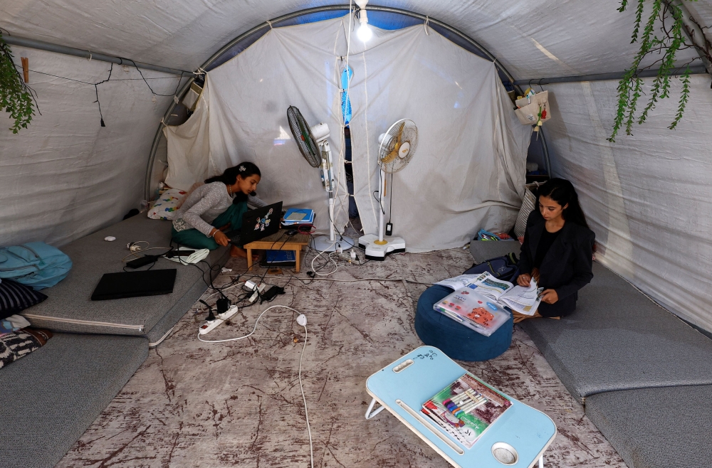 Palestinian student Raghad Loai Mhanna, who passed her high school exams while living in a tent after being displaced during the war, sits inside her tent in Deir al-Balah, central Gaza Strip October 19, 2025. — Reuters pic