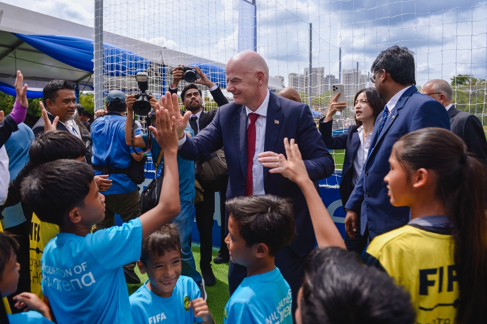 Fifa president Gianni Infantino interacts with pupils during the launch of the Fifa Arena at Sekolah Kebangsaan Sri Kelana, Kuala Lumpur, Oct 25, 2025.