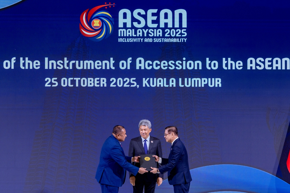 (From left) Timor-Leste Foreign Affairs and Cooperation Minister Bendito dos Santos Freitas, Foreign Minister Datuk Seri Mohamad Hasan and Thailand Foreign Affairs Minister Sihasak Phuangketkeow pose for a group photo during the ceremony for the accession of Timor-Leste to the Asean Charter and SEANWFZ Treaty ahead of the 47th Asean Summit in Kuala Lumpur October 25, 2025. — Picture by Firdaus Latif