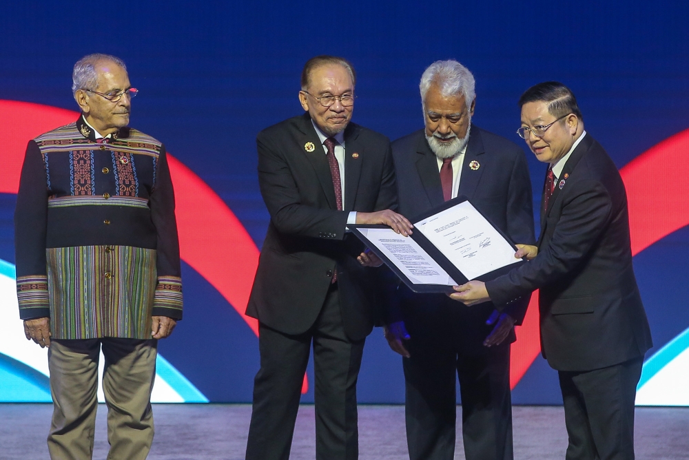 Prime Minister Datuk Seri Anwar Ibrahim hands over the Declaration on the Admission of Timor-Leste into Asean to Asean Secretary-General Dr Kao Kim Hourn, as Timor-Leste President José Ramos-Horta and Prime Minister Kay Rala Xanana Gusmão look on during the opening ceremony of the 47th Asean Summit and Related Summits at the Kuala Lumpur Convention Centre, October 26, 2025. — Picture by Yusof Isa