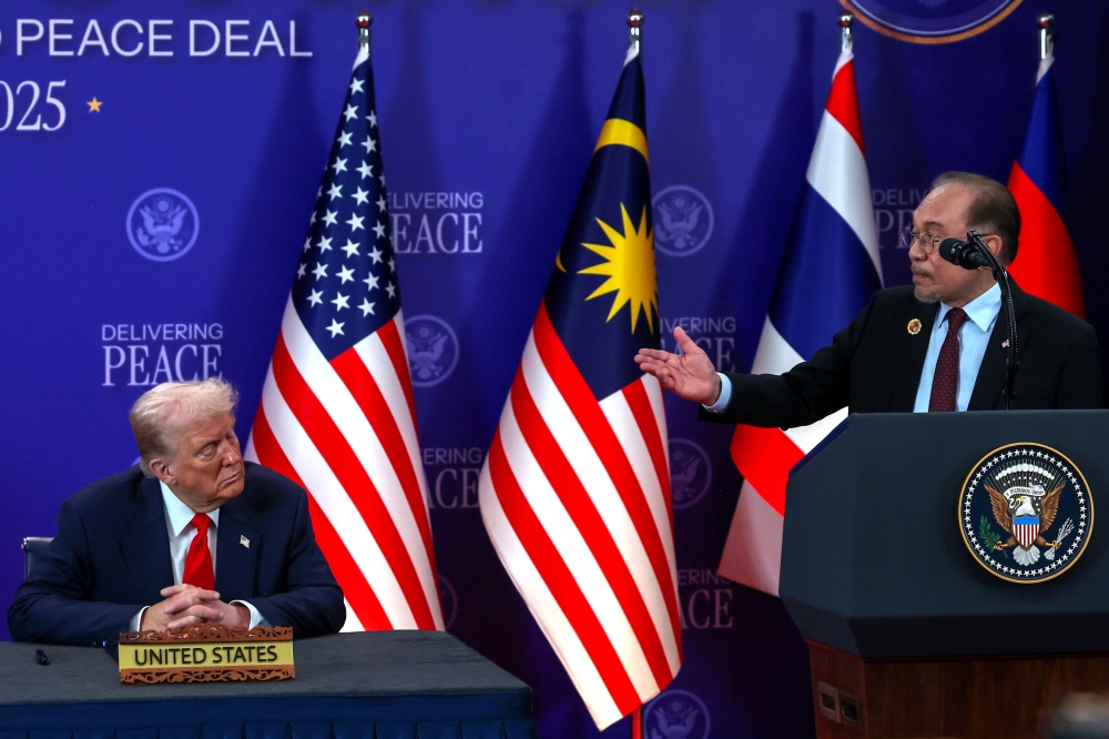 United States President Donald Trump and Malaysian Prime Minister Datuk Seri Anwar Ibrahim (right) share an elated moment during the signing of the Cambodia-Thailand peace deal at the 47th Asean Summit at the Kuala Lumpur Convention Centre October 26, 2025. — Bernama pic