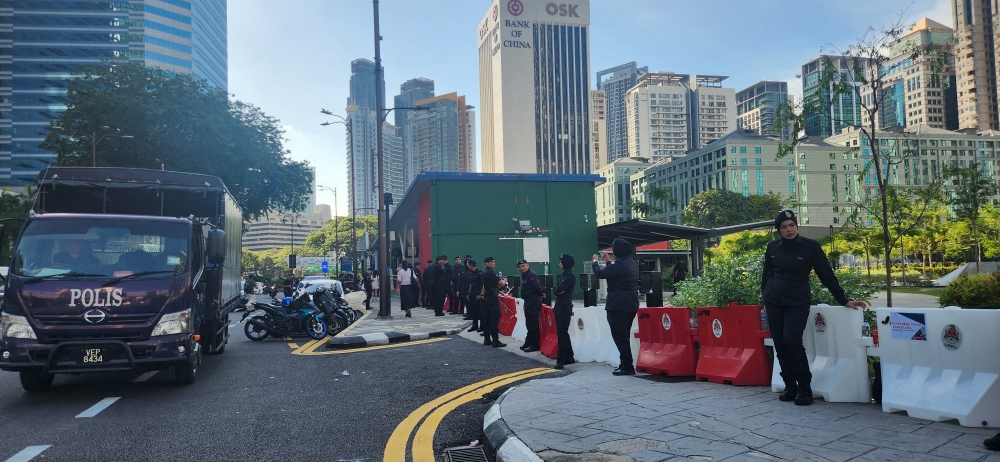 Police stationed outside the Ampang Park LRT station. — Picture by Arif Zikri