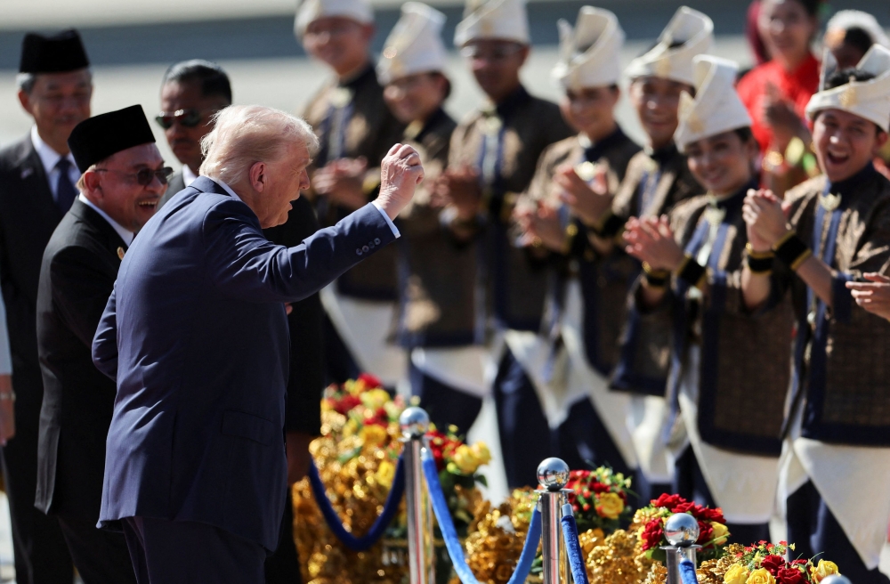 US President Donald Trump joins the performers in a dance during a welcoming ceremony after arriving at Kuala Lumpur International Airport, to attend the 47th Association of South-east Asian Nations (Asean) Summit, in Kuala Lumpur October 26, 2025. — Reuters pic