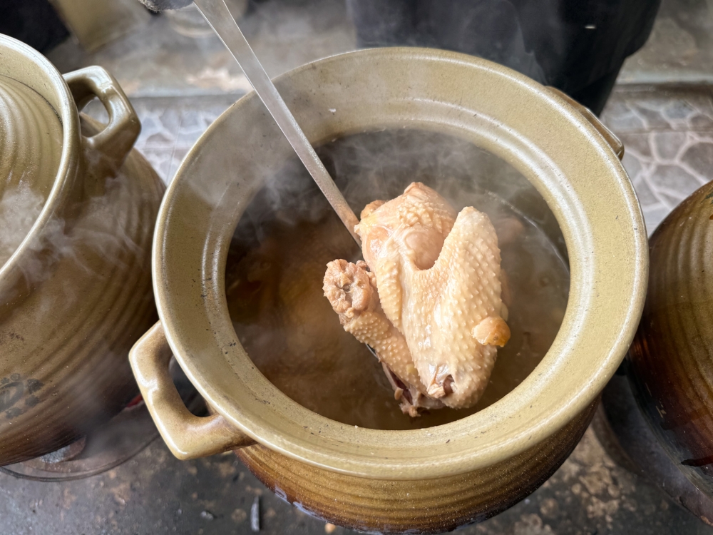 Even after long hours in the claypot, the free range hormone-free chicken remains intact with pull-apart meat. — Picture by Lee Khang Yi