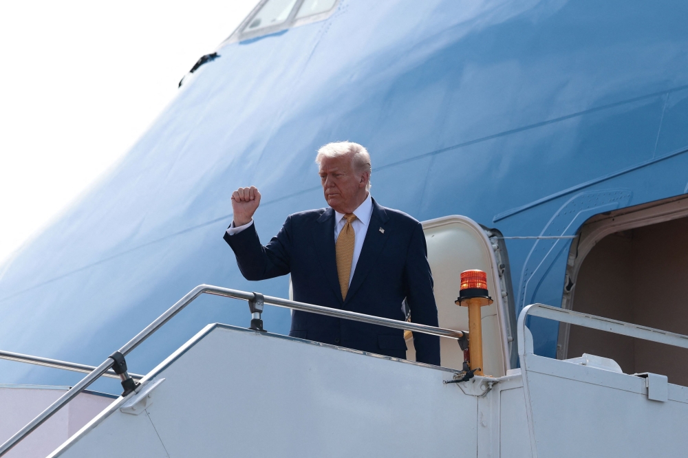 US President Donald Trump boards Air Force One as he departs for Japan at Kuala Lumpur International Airport in Kuala Lumpur, Malaysia, October 27, 2025. — Reuters pic