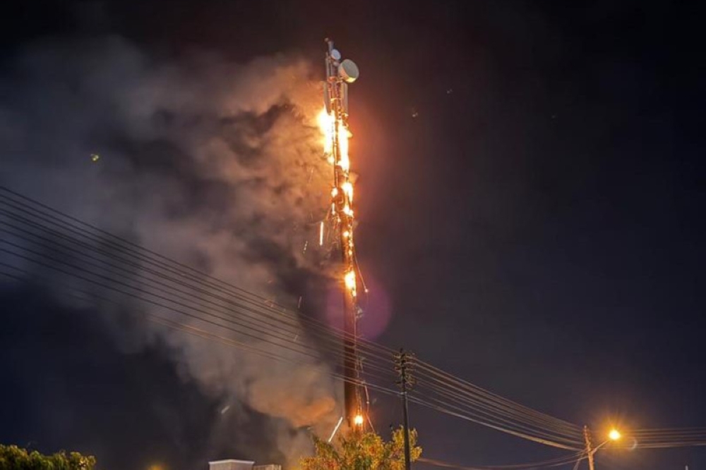 Flames engulf the telecommunication tower in Senadin. — Bomba pic via The Borneo Post 