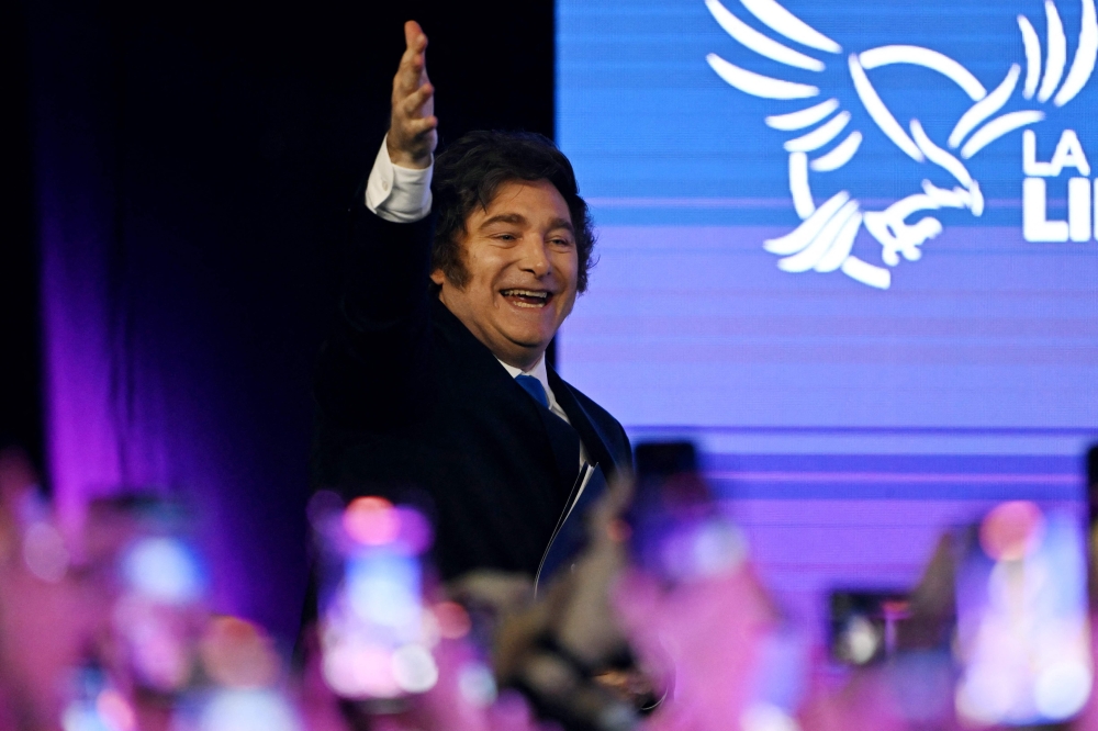 Argentina’s President Javier Milei waves to supporters as he arrives at the ruling party’s La Libertad Avanza headquarters following the results of the national midterm legislative election in Buenos Aires on October 26, 2025.  — AFP pic