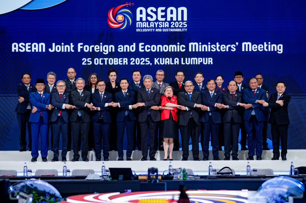 Foreign Minister Datuk Seri Mohamad Hasan and Investment, Trade and Industry Minister Tengku Datuk Seri Zafrul Abdul Aziz pose for a group photo during the Asean Joint Foreign and Economic Ministers’ Meeting ahead of the 47th Asean Summit, Kuala Lumpur Convention Centre October 25, 2025. — Picture by Firdaus Latif
