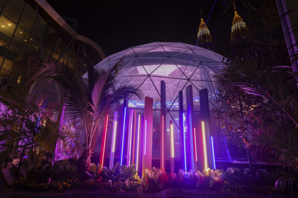 The transparent dome structure featuring flora and fauna motifs glows beautifully with vibrant lights come nightfall. — Picture by Bernama