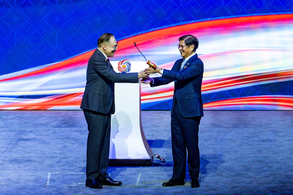 Prime Minister Datuk Seri Anwar Ibrahim hands over the gavel for the Asean Chairmanship to Philippines President Ferdinand Marcos Jr during the closing ceremony of the 47th Asean Summit and Related Summits in Kuala Lumpur October 28, 2025. — Picture by Firdaus Latif