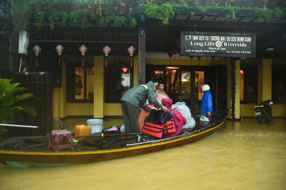 People are evacuated from a hotel on a boat in flood waters following heavy rains in Hoi An in central Vietnam on October 27, 2025. — AFP pic 