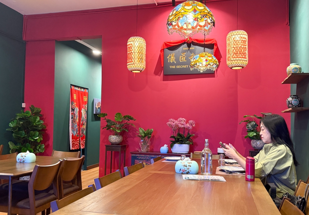 Inspired by the old wooden signboards, this custom-made version uses Chinese and English words to proclaim the name of the business. — Picture by Lee Khang Yi