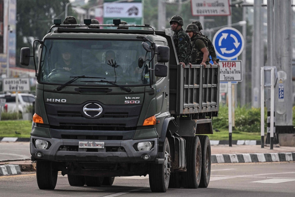 File picture of Royal Thai Army soldiers being transported on the back of an army truck in the Thai border province of Si Sa Ket July 26, 2025. Thailand is ready to repatriate 18 Cambodian prisoners of war (POWs) in accordance with international principles if Cambodia demonstrates sincere and tangible cooperation on four key issues. — AFP pic