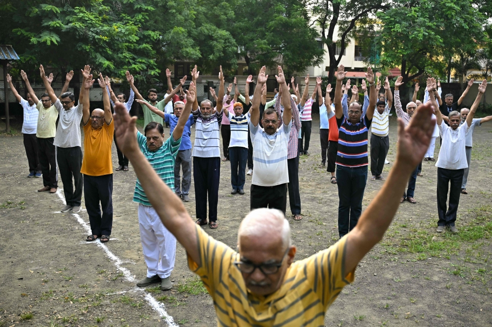 RSS volunteers take part in morning drills during a shakha, or training session, of the Hindu nationalist organisation at a park in Nagpur on October 3, 2025. — AFP pic