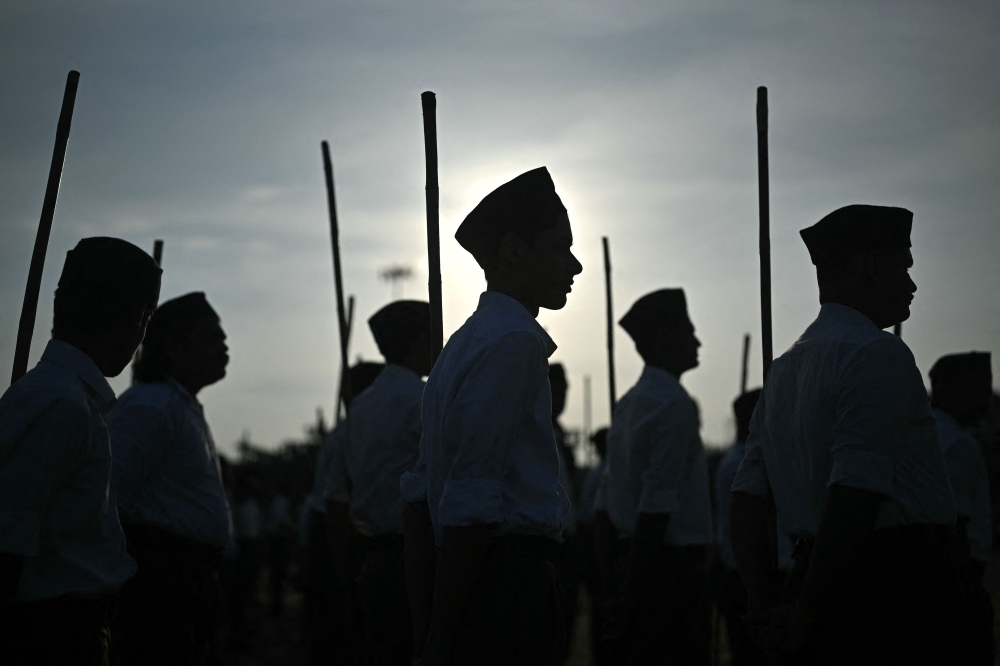 RSS volunteers brandishing bamboo sticks as part of the Hindu nationalist organisation's centenary celebrations at Reshimbagh Ground in Nagpur on October 2, 2025. — AFP pic